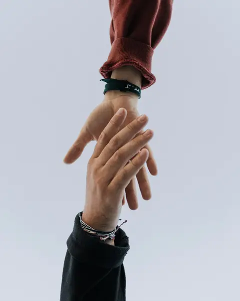 Two hands reaching for each other