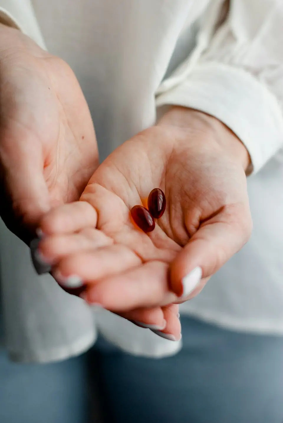 Two capsules in an open palm