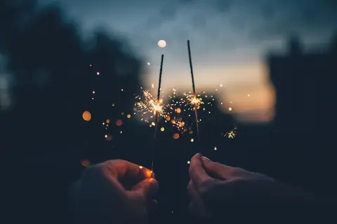 Two sparklers at dusk